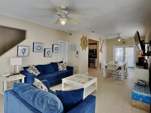 a living room with a blue couch and a table at La Favorita in Navarre