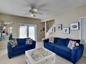 a living room with blue couches and a table at La Favorita in Navarre