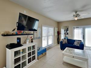 a living room with a blue couch and a flat screen tv at La Favorita in Navarre
