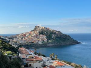 a town on top of a hill next to the ocean at Domus Lavinia in Badesi