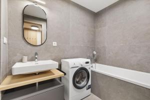 a bathroom with a washing machine and a sink at LAM Terracotta - AC - Balcony in Bratislava +13 photos