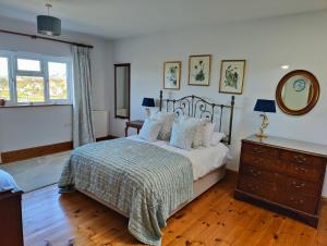 a bedroom with a bed and a dresser and a window at Family Escape - Garden, Parking, Pet friendly in Salcombe