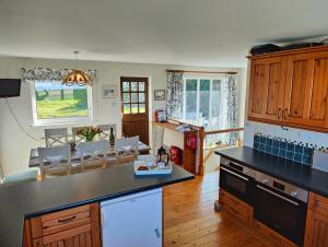 a kitchen with a counter and a dining room at Family Escape - Garden, Parking, Pet friendly in Salcombe