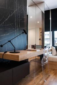 a desk with a lamp and a chair in a room at 2 Sidebyside Suites In Athens Riviera By The Olon in Athens +33 photos