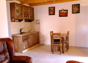 a kitchen and dining room with a table and chairs at Sunlight Cottage Maya in Virpazar