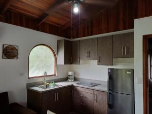 a kitchen with wooden cabinets and a stainless steel refrigerator at Gray House Domenico in Potrero