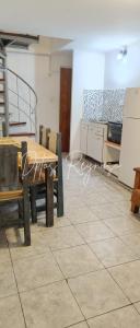 a dining room with a table and chairs in a room at Dptos Reynoso in Villa Mercedes +1 photo