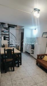 a dining room with a table and chairs in a room at Dptos Reynoso in Villa Mercedes