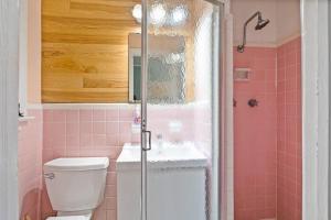 un bagno rosa con un water e un lavandino di Dive into the 50s- Restored Motel in St Augustine a St. Augustine