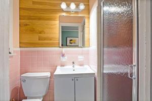 un bagno con un water, un lavandino e uno specchio di Dive into the 50s- Restored Motel in St Augustine a St. Augustine 1 altra foto