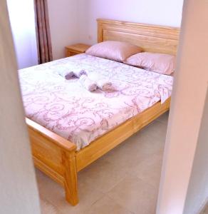 a bedroom with a bed with two towels on it at Sunlight Cottage Maya in Virpazar