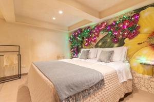 a bedroom with a bed with a flower mural on the wall at Palazzo Natoli Boutique Hotel in Palermo