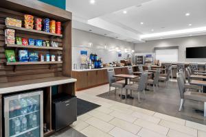 a restaurant with a bar and tables and chairs at Best Western San Bernardino Hotel in San Bernardino