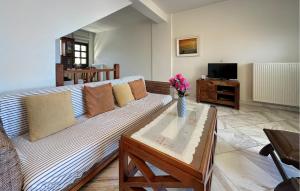 a living room with a couch and a vase of flowers at Amazing Home In Diakopto Achaias P in Diakopto