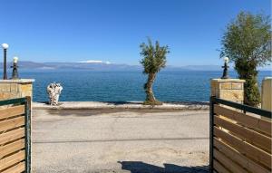 a gate with a view of the water at Amazing Home In Diakopto Achaias P in Diakopto +29 photos