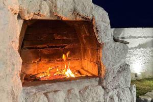 a brick oven with a fire in it at Villa Santo Stefano in Monopoli