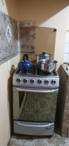 a stove with pots and pans on top of it at Mi casa tu casa. My house in La Paz