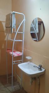 a bathroom with a shelf and a sink and a mirror at Mi casa tu casa. My house in La Paz +19 photos