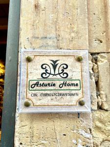 a sign for an outside home on a stone wall at Asturie Home in Siracusa