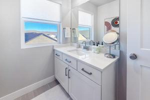 a white bathroom with a sink and a mirror at Silver Creek Sanctuary in Park City