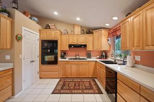 a kitchen with wooden cabinets and a rug on the floor at 164 Jillian - Private peaceful retreat in Three Rivers