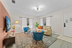 a living room with a couch and a table at SUPER BOHO - Lake Toho Timeless Charm in Kissimmee