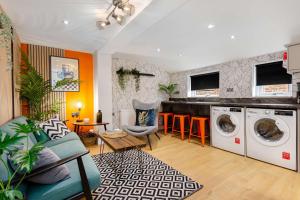 a living room with a washer and dryer at Ashton Getaway Sleeps 14 Free Parking in Dukinfield