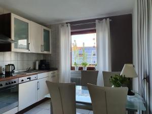 a kitchen with a table and chairs and a window at Ferienhaus Casa Maria In Ehrenberg An Der Rhön in Ehrenberg