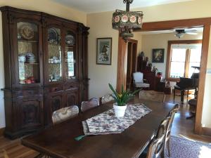 a dining room with a table and a china cabinet at Attwood House Bed and Breakfast near Manhattan, KS in Randolph