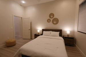 a bedroom with a bed with two night stands and two lamps at Central To Phoenix and Scottsdale Spacious 3BR Escape in Phoenix! in Phoenix