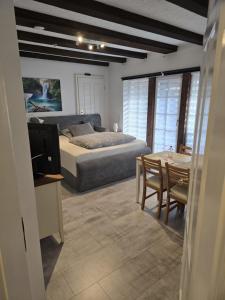 a bedroom with a bed and a table and a dining room at Ahauser Business- und Ferien-Appartement 29qm in Ahausen