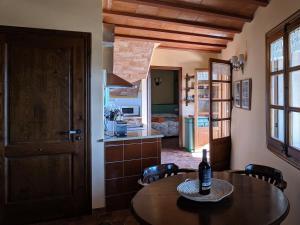 a kitchen with a table with a bottle of wine on it at L'Acadèmia de La Vilella Baixa in La Vilella Baixa +34 photos