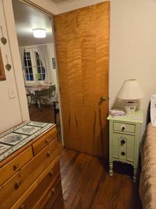 a bedroom with a door leading to a bedroom with a table at Lakefront! Twin Birch Resort - The Green Laker in Honor +42 photos