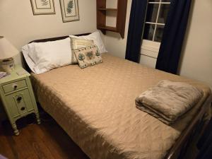 a bed in a bedroom with a nightstand and a bed sidx sidx at Lakefront! Twin Birch Resort - The Green Laker in Honor
