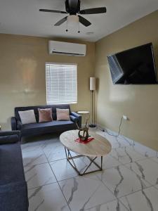 a living room with a couch and a tv at Sofia apartment in Puerto Peñasco