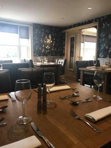 a table in a restaurant with glasses and utensils at Horse and Groom in Holbeach
