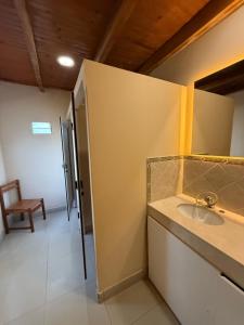 a bathroom with a sink and a mirror and a chair at Hotel Flair Concordia in Concordia