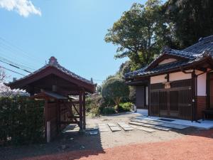 a small house with a gate and a building at 薬医門の宿 in Katori +72 photos