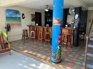 a large blue pole in a room with a bar at Hotel Martin in Corozal