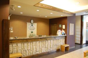 a restaurant with a reception counter in a building at Hotel Route-Inn Court Karuizawa in Miyota