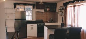 a kitchen with a refrigerator and a counter top at Salón y habitaciones in San Patricio