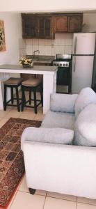 a kitchen with a table and a white refrigerator at Salón y habitaciones in San Patricio +36 photos