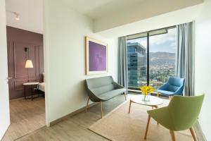 a living room with a table and chairs and a room with a view at Studio 56 by Terrado in Antofagasta