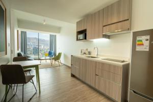 a kitchen with a sink and a table with a dining room at Studio 56 by Terrado in Antofagasta +21 photos
