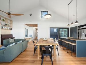 a kitchen and living room with a table and chairs at Birdsong Blackheath in Blackheath