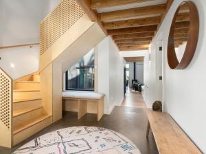a room with a staircase and a table and a rug at Birdsong Blackheath in Blackheath