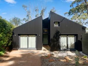 a black house with two white doors at Birdsong Blackheath in Blackheath