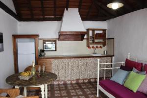 a living room with a table and a couch at Casitas La Montañita in El Paso