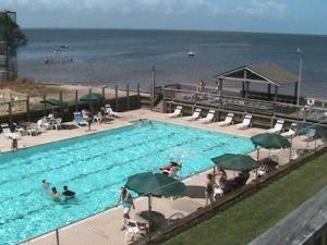 a large swimming pool next to the beach at Canal Front Boater's Paradise in Kill Devil Hills
