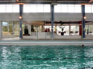 a person in the water in a swimming pool at Holiday apartment in Wyk with swimming pool in Wyk auf Föhr